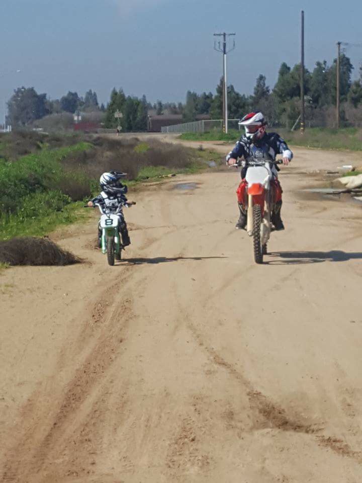 Geoff dirt biking with his son